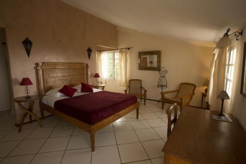 a bedroom with a bed and a table and chairs at Villa Laurina in Saint-Paul