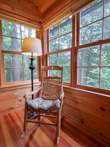 a rocking chair in a room with windows at Finlays Cove on the Lake in Colchester