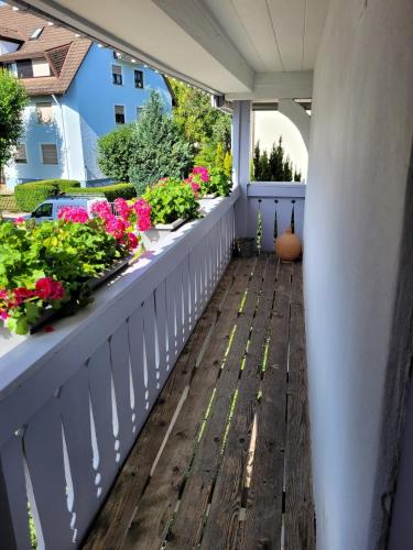 a balcony with flowers and plants on it at Ferienhaus im Gässle, Kirchzarten, Dreisamtal in Kirchzarten