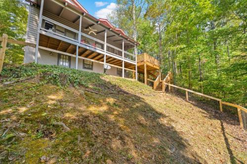 a house on top of a hill in the woods at The Grey Moose in Blairsville