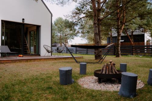 a playground in a yard with a swing at Osada pod Gwiazdami & SPA - Premium blisko jeziora, ogrodzony, ognisko, grill, taras, las, Kajaki, Plaża, Jeziora in Łasko