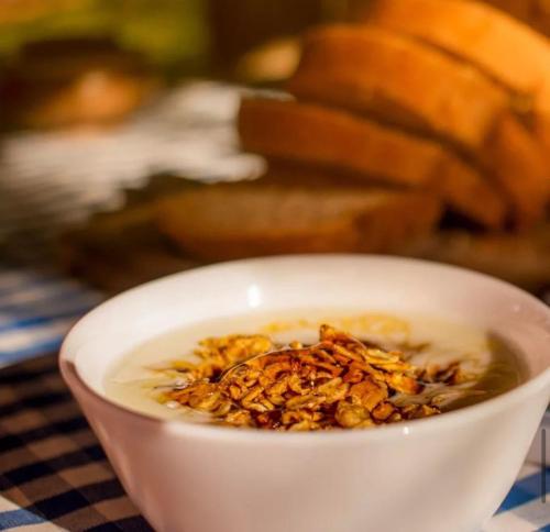a bowl of soup with nuts in it on a table at Chalés Del'Minas in Passa Quatro