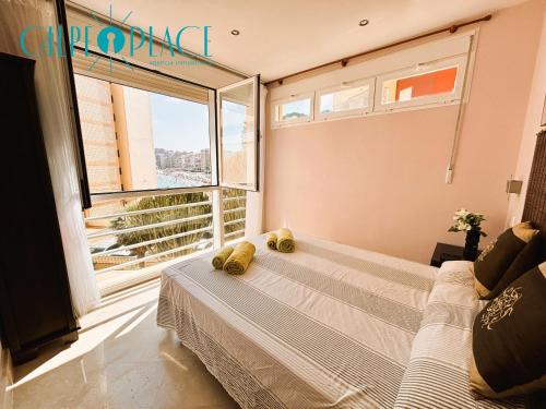 a bedroom with a bed and a large window at Kenya 1ª Linea in Ifach