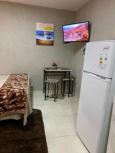 a kitchen with a white refrigerator and a table at LFA House in San Lorenzo