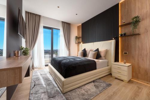 a bedroom with a bed and a desk and a television at Villa Liliana Vodice in Vodice