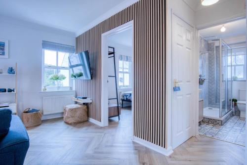 a living room with a hallway with a large mirror at Kilmore House - 2 Bedroom Apartment - Tenby in Tenby