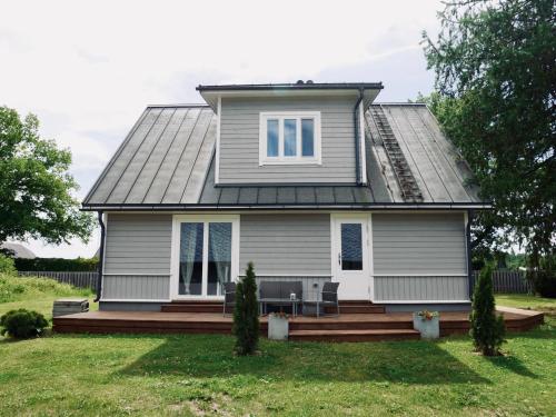a house with a porch and a deck at Sportsmen´s Holiday House in Otepää