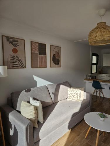a living room with a couch and a table at Canaima 112 Puerto Rico in Puerto Rico de Gran Canaria