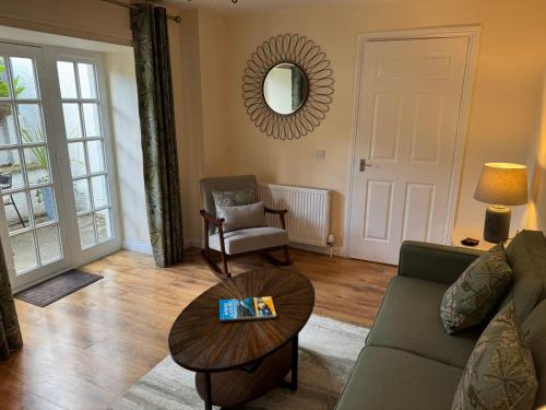 a living room with a couch and a table at 20a, By The Ness in Inverness