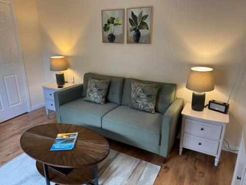 a living room with a couch and a table at 20a, By The Ness in Inverness
