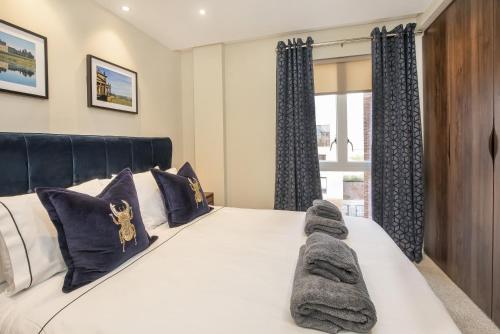 a bedroom with a large white bed with blue curtains at York Central No 1, within the city walls, free parking in York