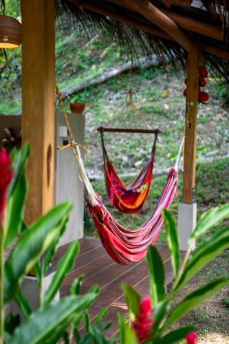 a couple of hammocks hanging from a porch at Canto Tayrona Ecolodges in Buritaca