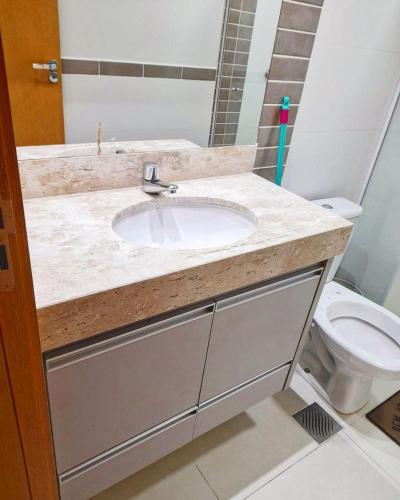 a bathroom with a sink and a toilet at Parque veredas resort in Rio Quente