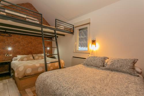 a bedroom with a bed and a bunk bed at DUPLEX TEMPLO NEVADO con 2 Parking cubiertos gratis in Sierra Nevada