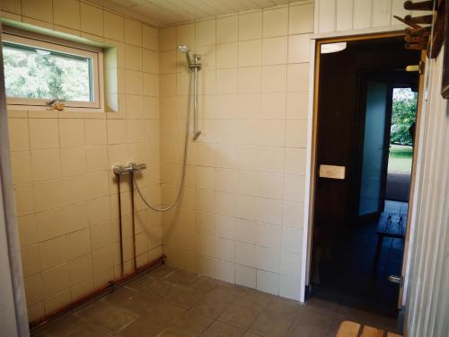 a bathroom with a shower and a door at Sportsmen´s Holiday House in Otepää