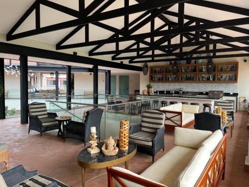 a living room with a bar with a couch and chairs at Boutique Hotel La Casona in Valle de Ángeles