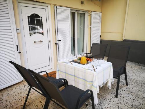 a table with a white table cloth on a patio at Sea View Apartment with 3 Bedrooms in Amfilochia in Amfilochía