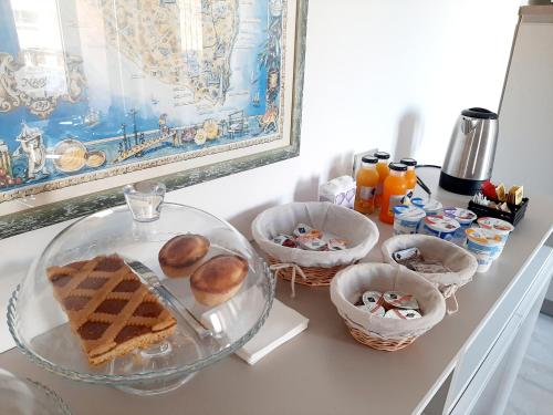 a counter with baskets of food and a glass plate at Dimora Gentile Lecce B&B in Lecce