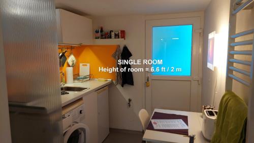 a kitchen with a sink and a washing machine at Unique 118 in Bremen