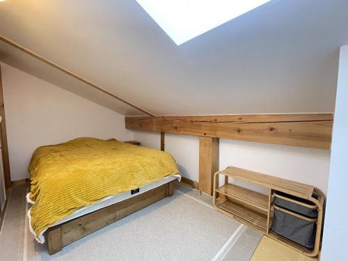 a small bedroom with a bed and a skylight at Duplex de Charme pour 6 Personnes, Proche Centre et Pistes de Ski - FR-1-505-209 in Notre-Dame-de-Bellecombe