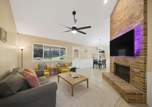 a living room with a couch and a fireplace at Cozy Brick Home in San Antonio
