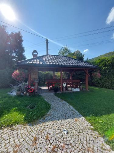a gazebo with a bench and a table at Domek na Leśnej Wisła in Wisła