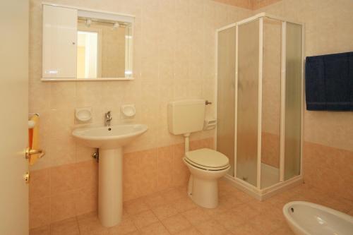 a bathroom with a toilet and a sink and a shower at Residence Cristoforo Colombo in Caorle