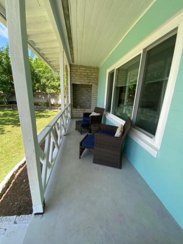 a screened porch with chairs and a fireplace on a house at Family House, heated pool in St. Augustine