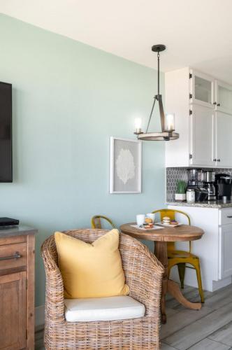 a kitchen with a wicker chair and a table in a kitchen at CDM 351 - Serendipity Sunrise in Galveston