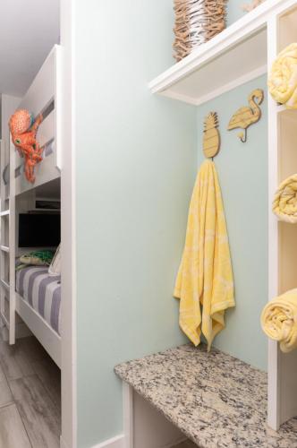 a childs room with a childs closet with a yellow towel at CDM 351 - Serendipity Sunrise in Galveston