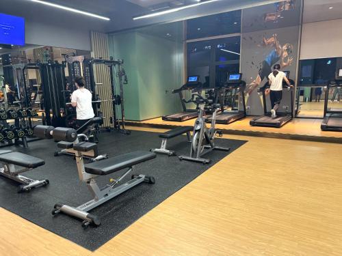 a gym with several people exercising on tread machines at Yushe High-altitude Night View Hotel-Guangzhou Tower Zhujiang New Town Branch Exclusive for the Canton Fair in Guangzhou