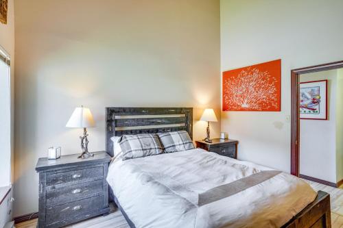 a bedroom with a large bed and two night stands at Ski-InandSki-Out Brian Head Condo with Hot Tub! in Brian Head
