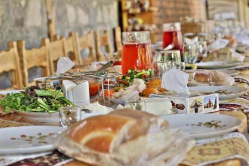 a long table with plates of food on it at Sun House in Yeghegnadzor