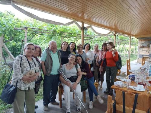 a group of people posing for a picture under a pavilion at Sun House in Yeghegnadzor
