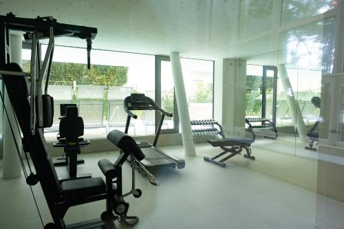 a gym with several tread machines in a room at StarPalace Elegance Apartment Jesolo SPA GYM POOL PARKING - a 2 passi dal mare in Lido di Jesolo
