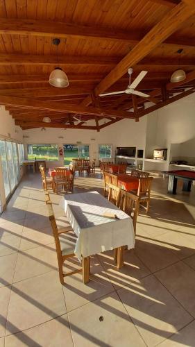 a living room with wooden ceilings and tables and chairs at El Principio Palace in Villa Cura Brochero