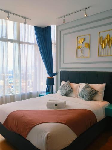 a bedroom with a large bed with a large window at Sky Suites KLCC by KD Luxury Suites in Kuala Lumpur