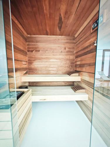 a sauna with wooden walls and a wooden ceiling at StarPalace Elegance Apartment Jesolo SPA GYM POOL PARKING - a 2 passi dal mare in Lido di Jesolo