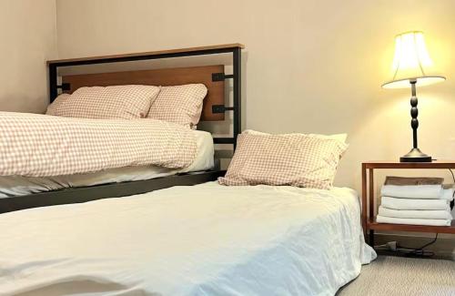 a bedroom with two beds and a lamp on a table at Maison Dongdaemun myeongdong hotel in Seoul