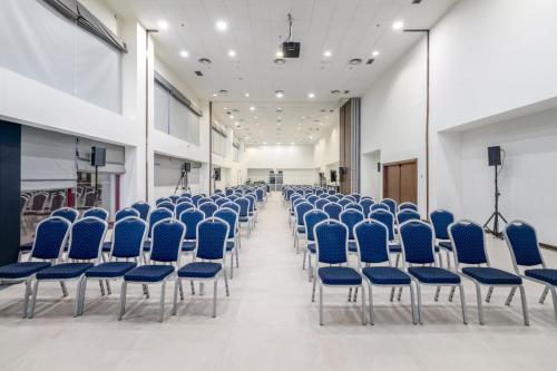 an empty room with blue chairs in a building at Exe Convention Plaza Madrid in Madrid