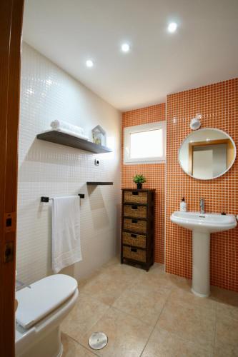 a bathroom with a toilet and a sink at OceanView Apartment in La Manga del Mar Menor