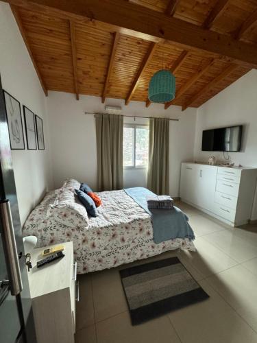 a bedroom with a large bed and a window at Lo de Hugo in Muñiz