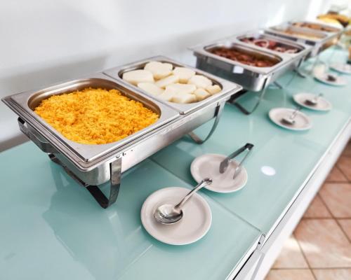 un buffet de comida en una mesa con platos en Casamar Pousada, en Paulista