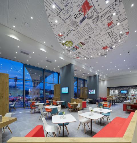 a restaurant with tables and chairs and a large ceiling at Ibis Konya in Konya