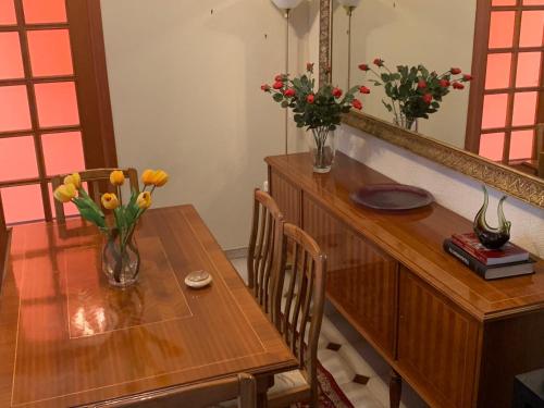 a dining room table with vases of flowers on it at Aelias home in Eleoúsa