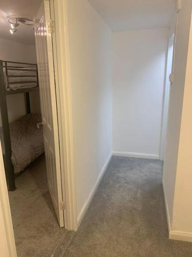a hallway with a door open to a bedroom at 2 Bedroom Home By Felixstowe Sea Front & Beach Street in Felixstowe