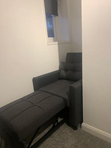 a living room with a couch and a chair at 2 Bedroom Home By Felixstowe Sea Front & Beach Street in Felixstowe