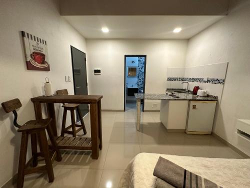 a kitchen with a table and a counter top at Lo de Hugo in Muñiz