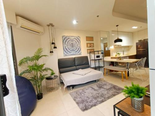 a living room with a couch and a table at Tambuli 1 Bedroom Beachfront Condo in Lapu Lapu City