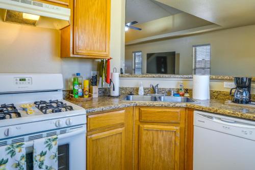 a kitchen with white appliances and a sink at Sunny El Paso Home with Private Yard! in Homestead Meadows South
